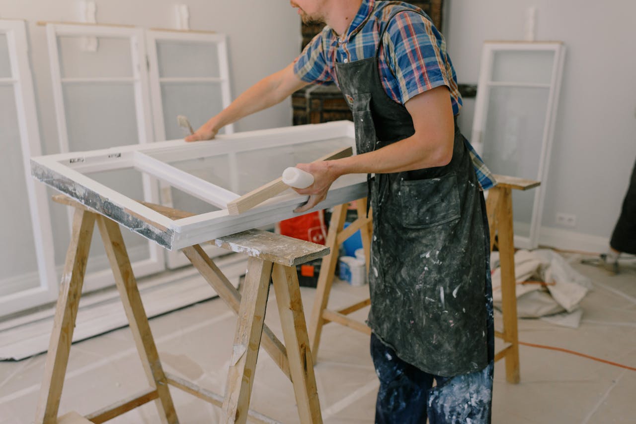 Mastering the First Impression: Your intriguing post title goes here A skilled craftsman repairing a window frame indoors using tools and expertise.