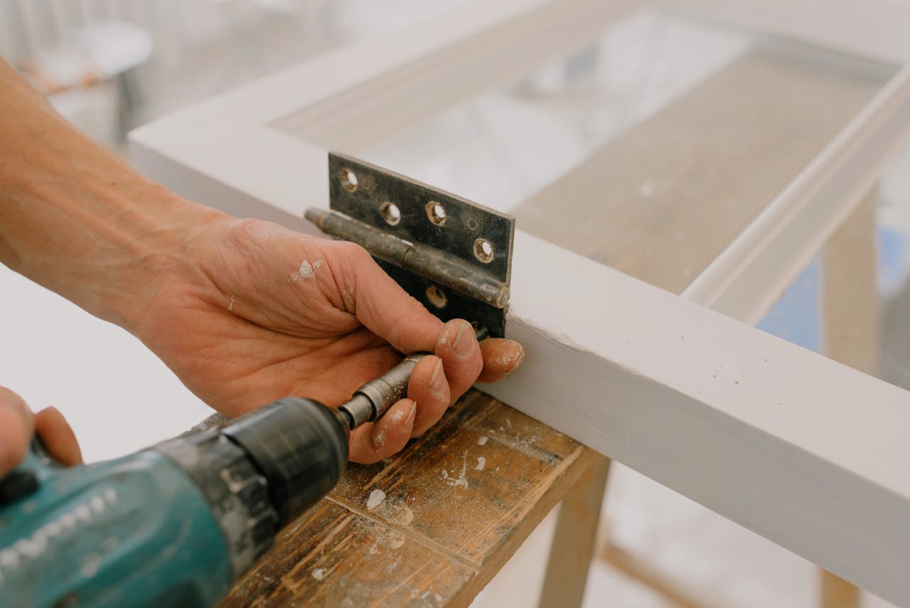 The Art of Drawing Readers In: Your attractive post title goes here Crop unrecognizable worker drilling metal hinge on white window frame during house renovation